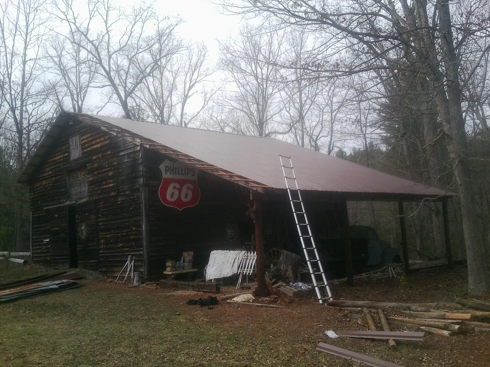 New metal roof on an open sided timber barn with a vintage sign in Comfort