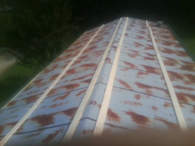 Rusted metal roof panels with new wood purlins before replacement — Storm Damage Roof Repair in Comfort by Roofing Brothers
